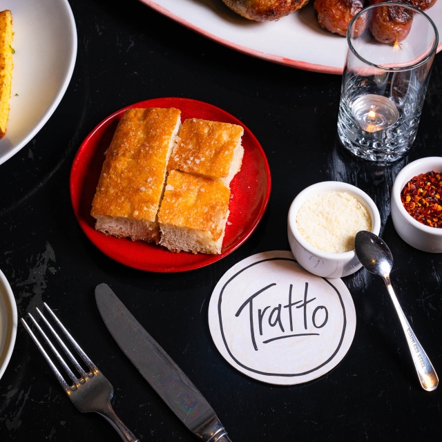 Close up of food on plates prepared by Tratto