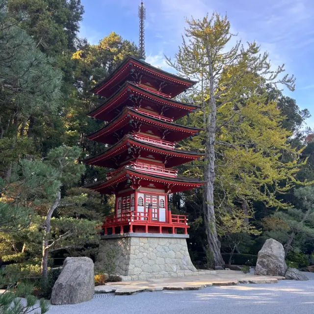 Five-tiered red pagoda in the Japanese Tea Garden, set among trees and rock garden landscaping