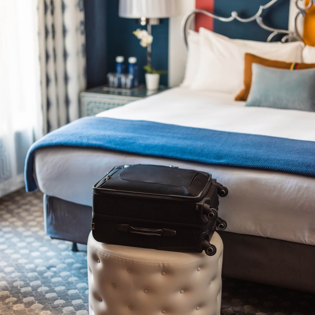 Luggage sitting on a stool in a bedroom at The Marker