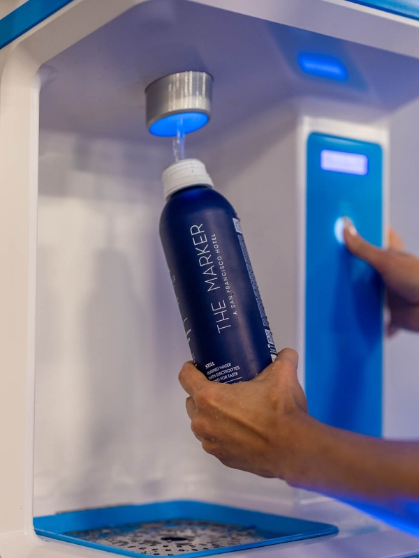 A woman filling up a water bottle at The Marker