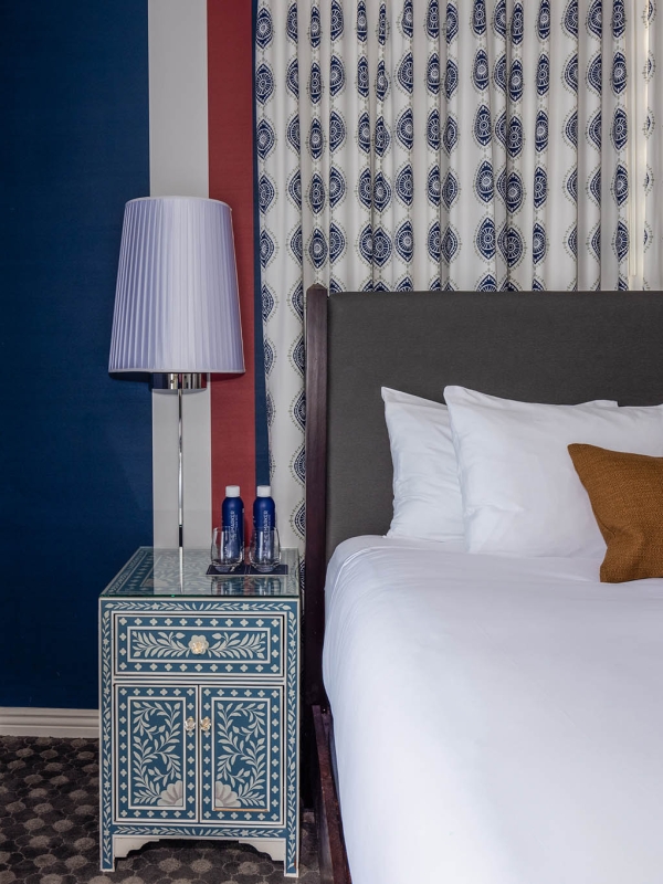 A nightstand sitting next to a bed at The Marker