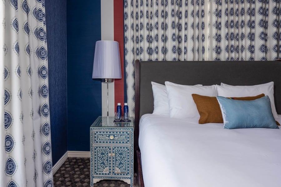 A nightstand sitting next to a bed at The Marker