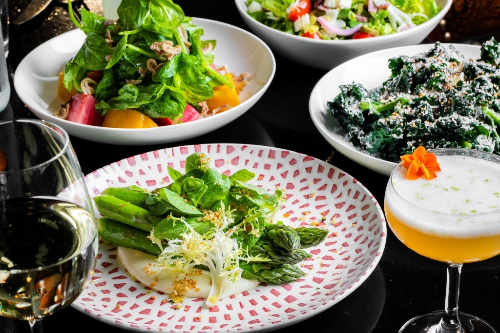 three salads and a cocktail prepared by tratto restaurant in marker hotel in san francisco